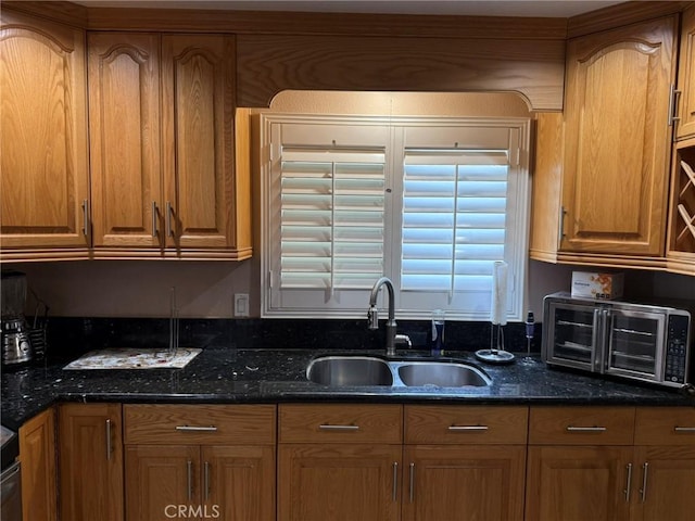 431 W M St, Colton, CA 92324 - kitchen featuring a sink, dark stone counters, and brown cabinets