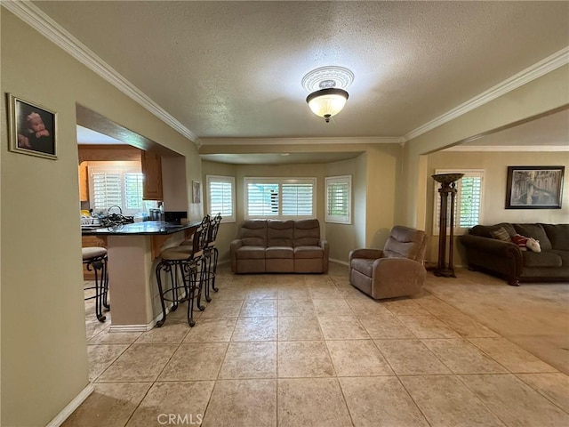 431 W M St, Colton, CA 92324 - living room featuring a textured ceiling, crown molding, light tile patterned floors, and baseboards