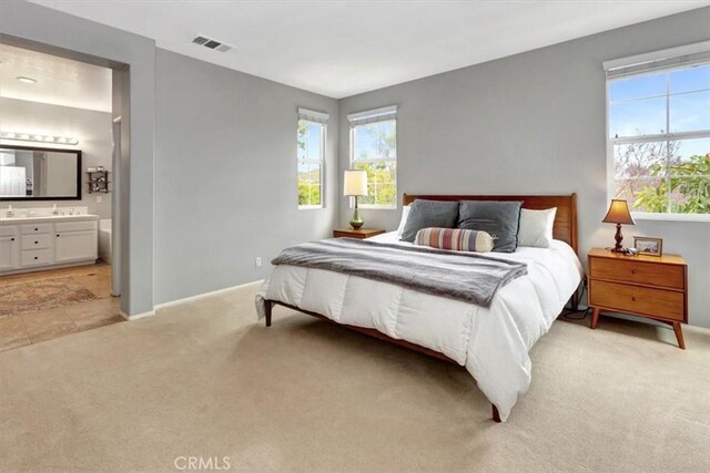 8 Marston Ln, Ladera Ranch, CA 92694 - bedroom with light carpet, baseboards, and ensuite bathroom