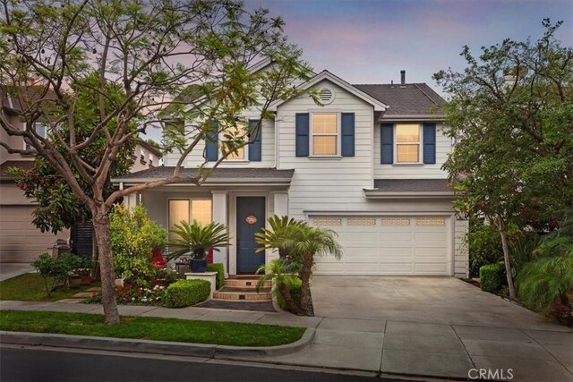 8 Marston Ln, Ladera Ranch, CA 92694 - traditional-style house with concrete driveway, an attached garage, and a shingled roof