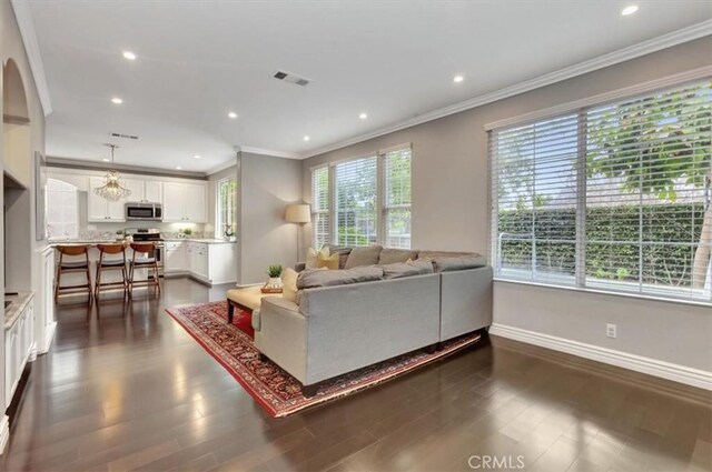 8 Marston Ln, Ladera Ranch, CA 92694 - living room with crown molding, baseboards, recessed lighting, dark wood-type flooring, and arched walkways