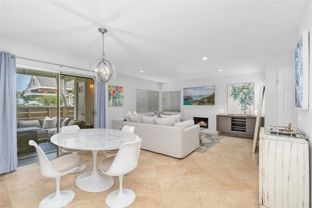 34132 Selva Rd Unit 252, Dana Point, CA 92629 - dining area with recessed lighting, a brick fireplace, and a chandelier