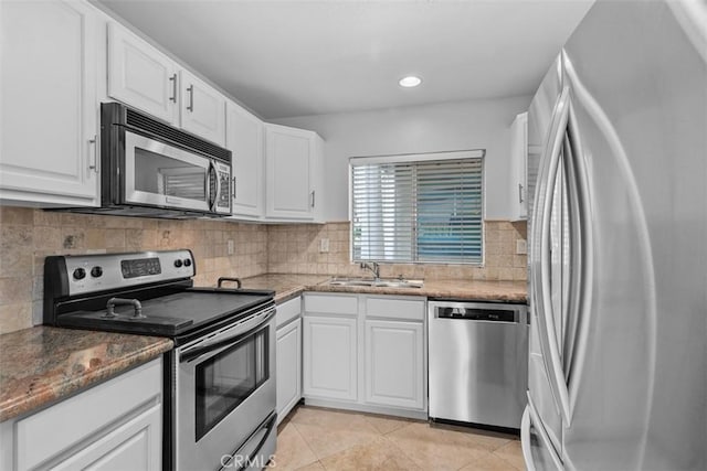 34132 Selva Rd Unit 252, Dana Point, CA 92629 - kitchen featuring appliances with stainless steel finishes, white cabinets, decorative backsplash, light tile patterned floors, and recessed lighting