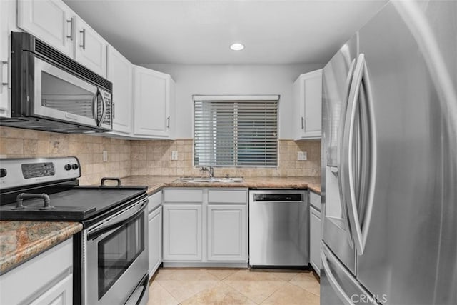 34132 Selva Rd Unit 252, Dana Point, CA 92629 - kitchen with appliances with stainless steel finishes, a sink, white cabinets, recessed lighting, and light tile patterned floors