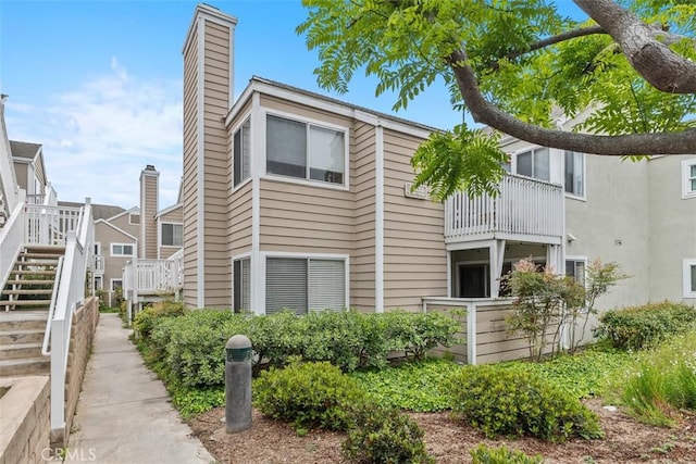 34132 Selva Rd Unit 252, Dana Point, CA 92629 - view of property exterior featuring a chimney and stairs