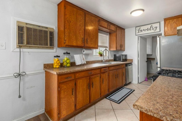 642 Carlsbad St, Spring Valley, CA 91977 - kitchen featuring appliances with stainless steel finishes, a sink, brown cabinets, and a wall unit AC