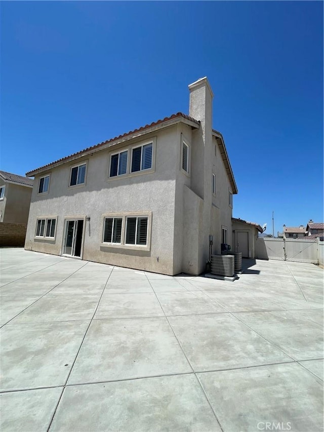 37000 Sabal Ave, Palmdale, CA 93552 - back of house with stucco siding, a patio, a chimney, and a tile roof