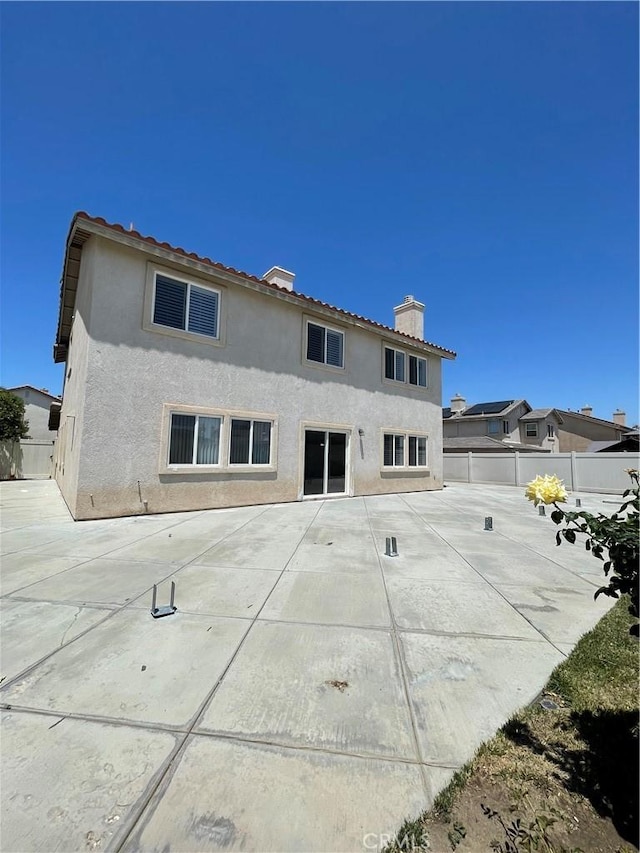 37000 Sabal Ave, Palmdale, CA 93552 - rear view of house with a chimney, stucco siding, and a patio