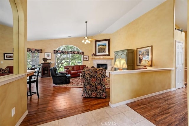 2860 Cathedral Ln, Arroyo Grande, CA 93420 - living room with a glass covered fireplace, a ceiling fan, wood finished floors, baseboards, and arched walkways