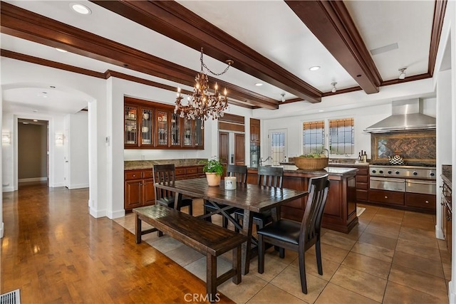 401 Piazza Lido, Newport Beach, CA 92663 - dining room featuring beamed ceiling, arched walkways, a chandelier, ornamental molding, and baseboards