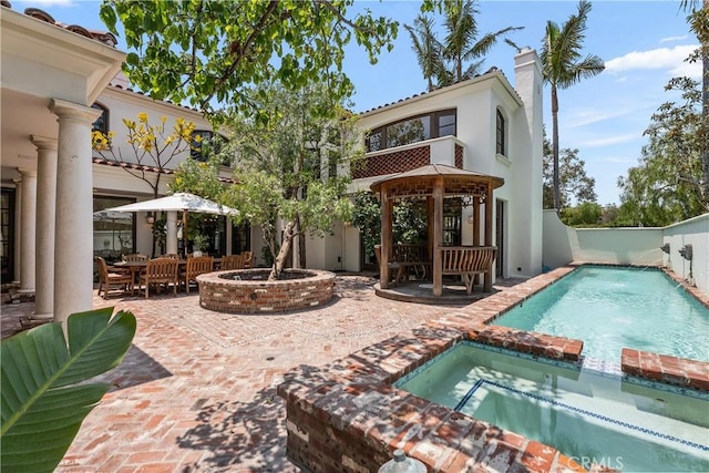 401 Piazza Lido, Newport Beach, CA 92663 - back of property with a gazebo, a patio area, a fire pit, stucco siding, and a pool with connected hot tub
