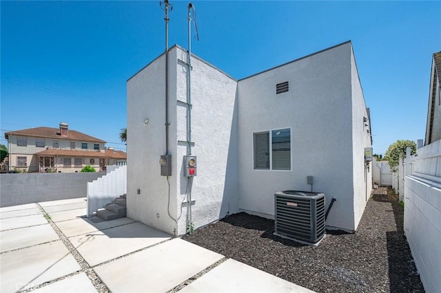 7513 S Cimarron St, Los Angeles, CA 90047 - rear view of property featuring a fenced backyard, a patio area, and stucco siding