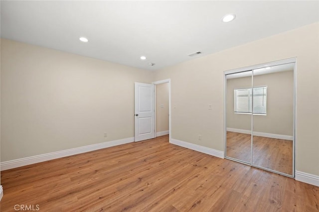 7513 S Cimarron St, Los Angeles, CA 90047 - unfurnished bedroom featuring light wood-style floors, a closet, and recessed lighting