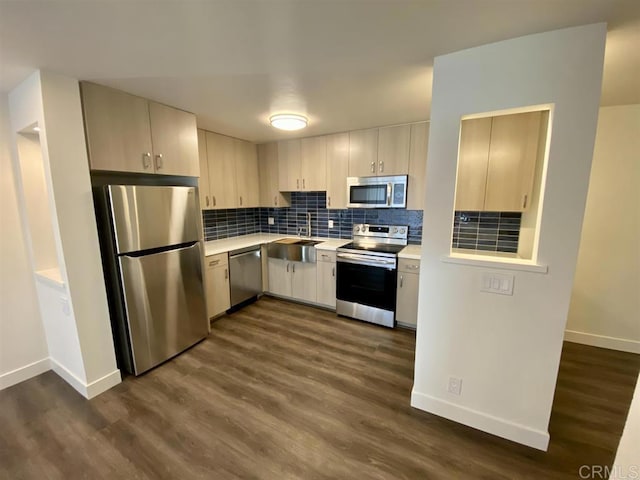 745 E Bradley Ave Unit 27, El Cajon, CA 92021 - kitchen with appliances with stainless steel finishes, a sink, light countertops, baseboards, and dark wood-style flooring