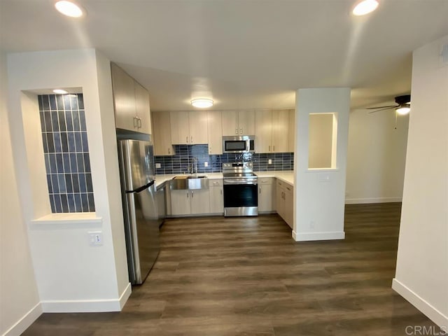 745 E Bradley Ave Unit 27, El Cajon, CA 92021 - kitchen featuring appliances with stainless steel finishes, light countertops, decorative backsplash, a ceiling fan, and dark wood-style floors