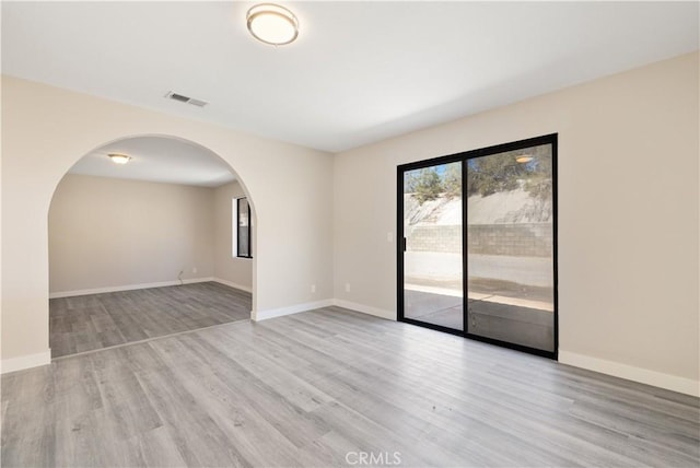 27505 Ventura Dr, Cathedral City, CA 92234 - empty room featuring wood finished floors, arched walkways, and baseboards