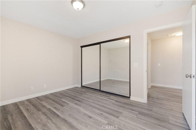 27505 Ventura Dr, Cathedral City, CA 92234 - unfurnished bedroom with light wood-style flooring, a closet, and baseboards