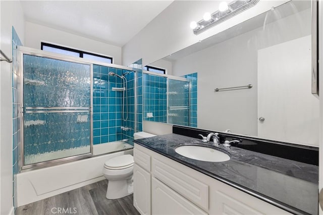 27505 Ventura Dr, Cathedral City, CA 92234 - bathroom with vanity, toilet, wood finished floors, and combined bath / shower with glass door