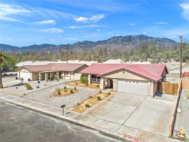 27505 Ventura Dr, Cathedral City, CA 92234 - single story home with a tiled roof, a mountain view, an attached garage, stucco siding, and driveway