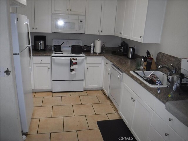 480 E 3rd St, Chico, CA 95928 - kitchen featuring white appliances, white cabinets, light tile patterned floors, and dark stone countertops