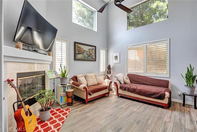 3506 Belvedere Way, Corona, CA 92882 - living room with ceiling fan, a high ceiling, plenty of natural light, wood finished floors, and a fireplace