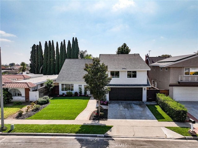 13621 Fairmont Way, Tustin, CA 92780 - view of front of home with an attached garage, concrete driveway, stucco siding, and a front yard
