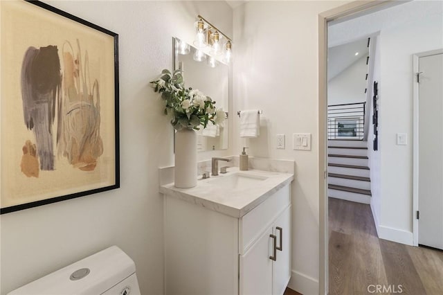 13621 Fairmont Way, Tustin, CA 92780 - half bath with vanity, wood finished floors, and baseboards