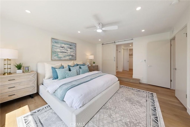 13621 Fairmont Way, Tustin, CA 92780 - bedroom with a barn door, wood finished floors, recessed lighting, and a ceiling fan
