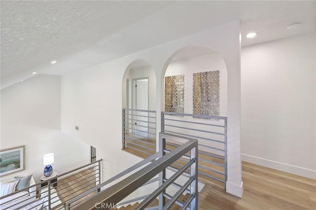 13621 Fairmont Way, Tustin, CA 92780 - hall featuring an upstairs landing, recessed lighting, wood finished floors, a textured ceiling, and baseboards