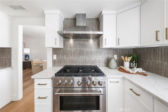 13621 Fairmont Way, Tustin, CA 92780 - kitchen with wall chimney range hood, stainless steel range, white cabinets, light wood finished floors, and light stone countertops