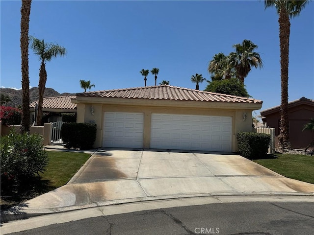 47845 Via Opera Ln, Quinta, CA 92253 - view of front of property featuring stucco siding, a tile roof, and driveway