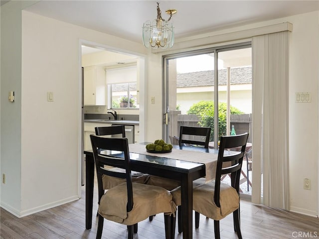 22652 Nadine Cir Unit A, Torrance, CA 90505 - dining space with a chandelier, light wood finished floors, and baseboards