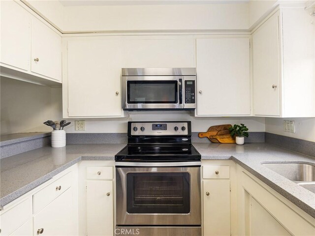 22652 Nadine Cir Unit A, Torrance, CA 90505 - kitchen featuring appliances with stainless steel finishes, white cabinets, and light countertops