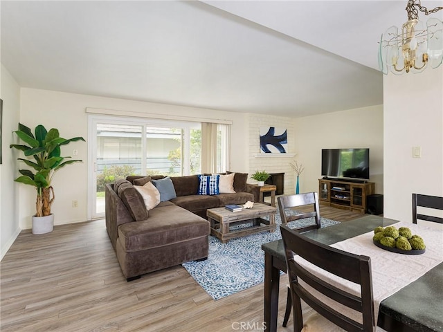 22652 Nadine Cir Unit A, Torrance, CA 90505 - living room with a chandelier, light wood-style flooring, and a fireplace