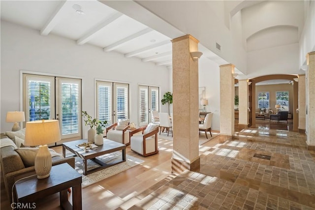 12165 Ojeda Ct, Tustin, CA 92782 - living area with ornate columns, beam ceiling, arched walkways, and a high ceiling