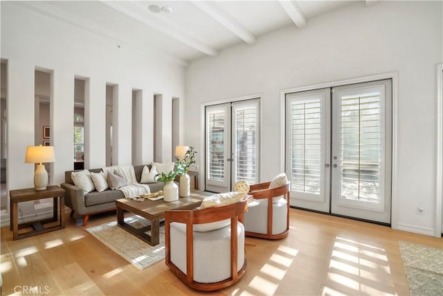 12165 Ojeda Ct, Tustin, CA 92782 - living room featuring french doors, beamed ceiling, healthy amount of natural light, and light wood finished floors