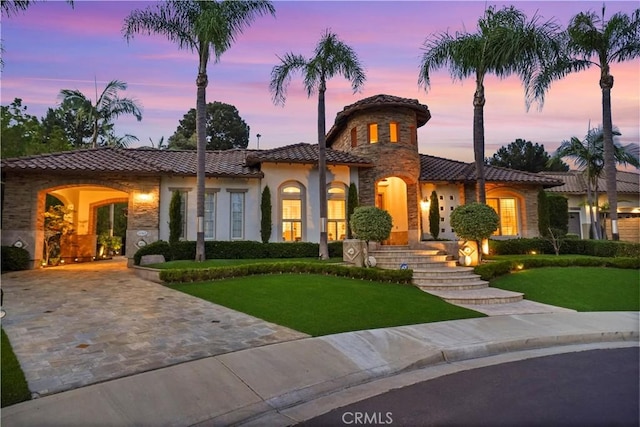 12165 Ojeda Ct, Tustin, CA 92782 - mediterranean / spanish-style house with a tiled roof, a front lawn, stucco siding, and stone siding