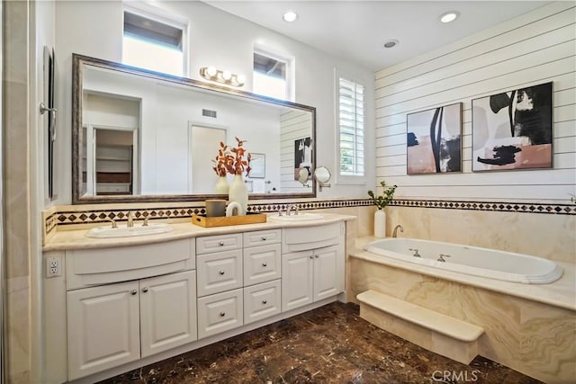 12165 Ojeda Ct, Tustin, CA 92782 - bathroom featuring marble finish floors, double vanity, a bath, tasteful backsplash, and recessed lighting
