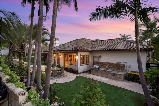 12165 Ojeda Ct, Tustin, CA 92782 - rear view of property with area for grilling, a tiled roof, stucco siding, and a patio
