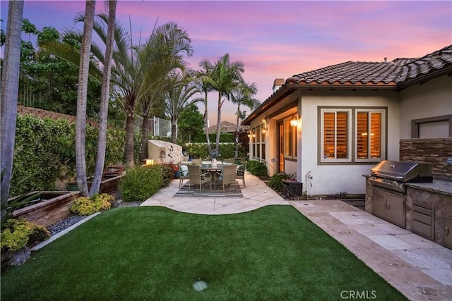 12165 Ojeda Ct, Tustin, CA 92782 - yard at dusk with exterior kitchen and a patio