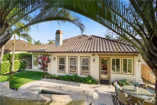 12165 Ojeda Ct, Tustin, CA 92782 - rear view of house with a patio area, a chimney, a tile roof, stucco siding, and outdoor dining area