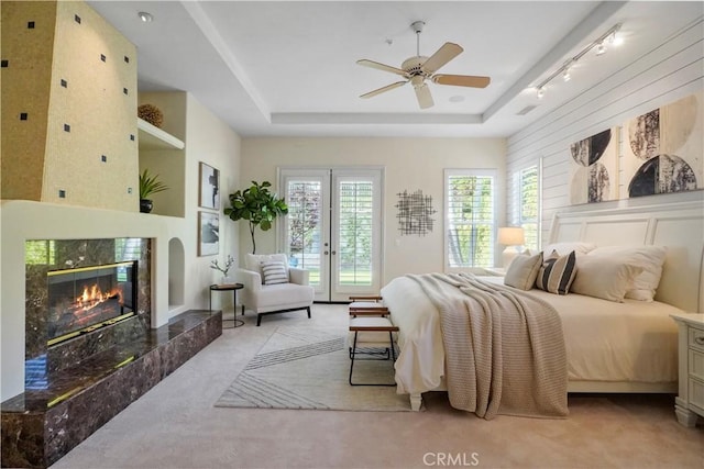 12165 Ojeda Ct, Tustin, CA 92782 - bedroom with light carpet, access to exterior, a high end fireplace, french doors, and multiple windows