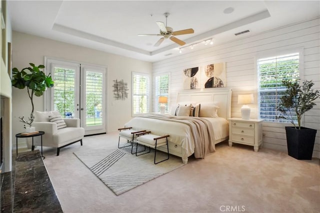 12165 Ojeda Ct, Tustin, CA 92782 - bedroom featuring a tray ceiling, access to exterior, light carpet, and ceiling fan