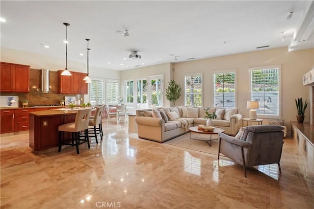 12165 Ojeda Ct, Tustin, CA 92782 - living area featuring healthy amount of natural light, recessed lighting, and light marble finish floors