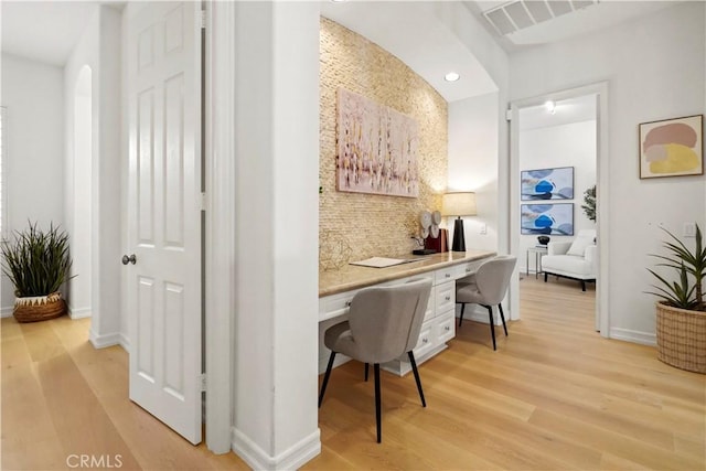 12165 Ojeda Ct, Tustin, CA 92782 - office area featuring built in desk, light wood-style floors, and baseboards