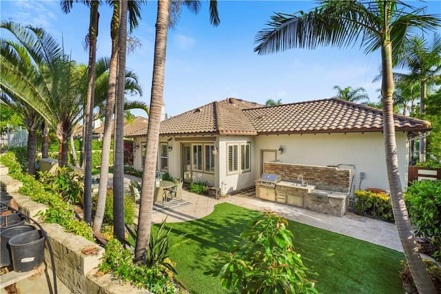 12165 Ojeda Ct, Tustin, CA 92782 - rear view of property featuring area for grilling, a tile roof, stucco siding, a patio area, and a yard