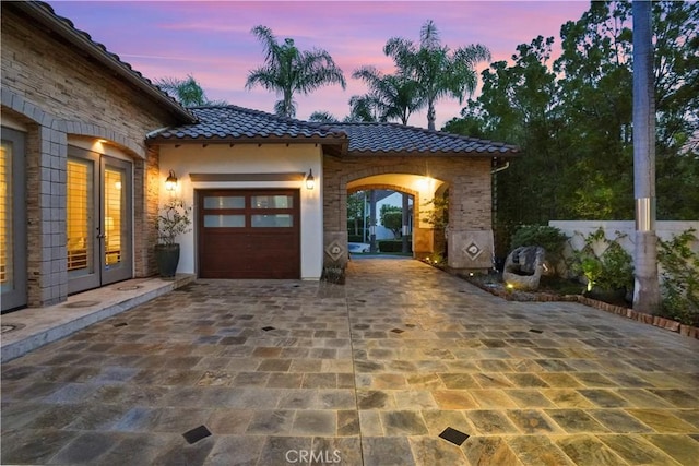 12165 Ojeda Ct, Tustin, CA 92782 - view of patio / terrace featuring french doors, an attached garage, and decorative driveway