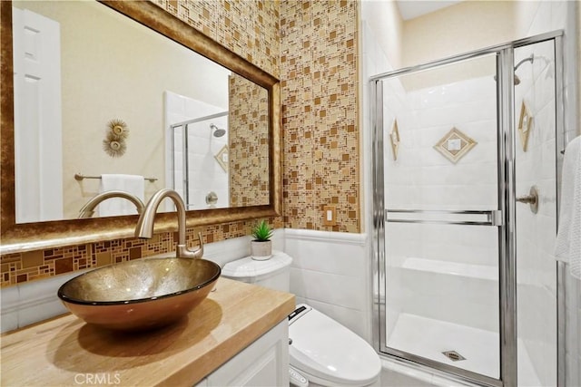 12165 Ojeda Ct, Tustin, CA 92782 - bathroom with vanity, tile walls, a shower stall, toilet, and wainscoting