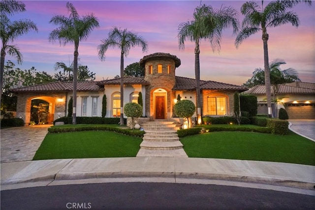 12165 Ojeda Ct, Tustin, CA 92782 - mediterranean / spanish-style home with a tiled roof, a yard, stucco siding, and driveway