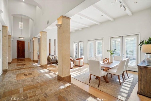 12165 Ojeda Ct, Tustin, CA 92782 - dining room featuring healthy amount of natural light, beamed ceiling, arched walkways, french doors, and decorative columns